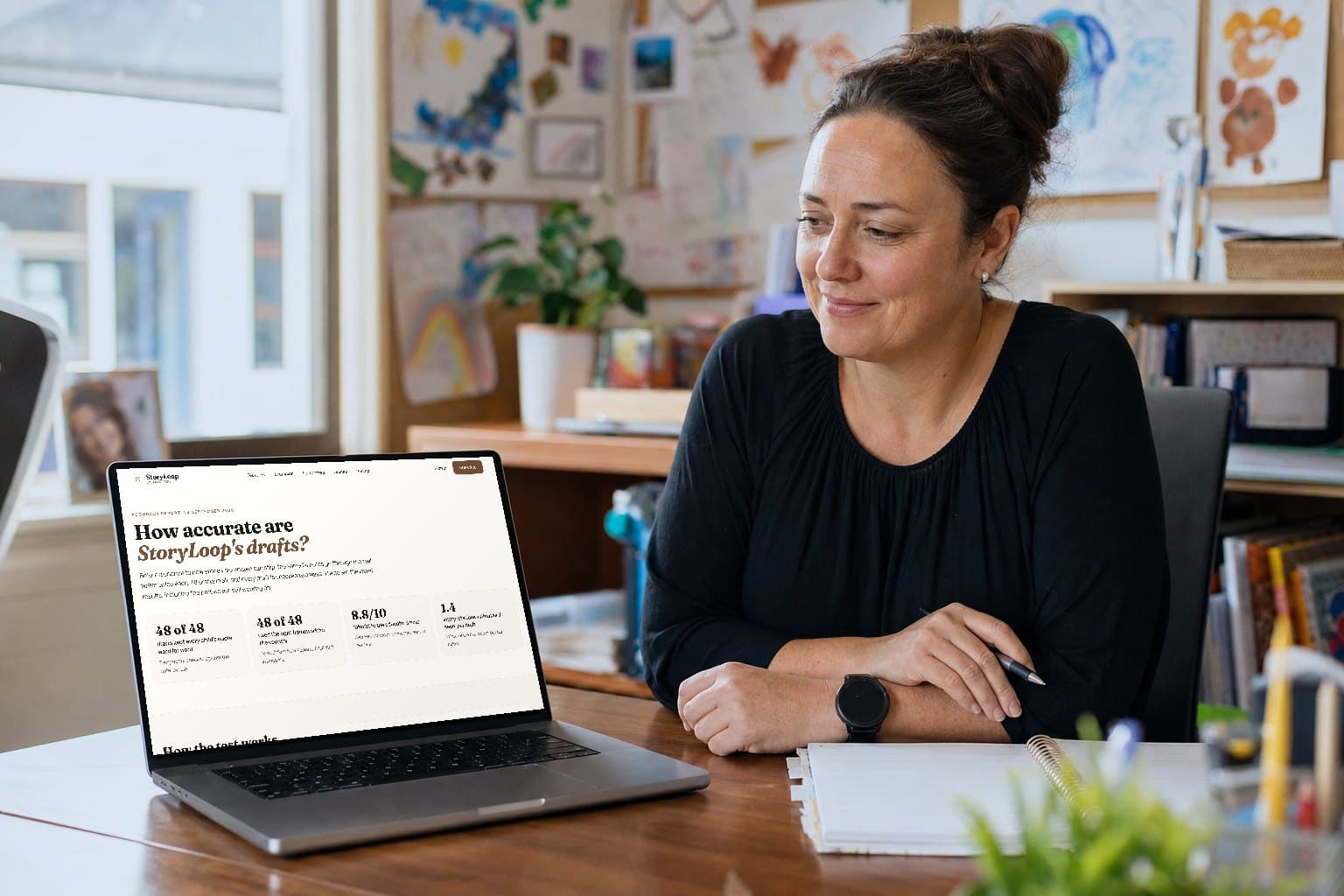 A centre manager at her desk reading StoryLoop's accuracy report on a laptop